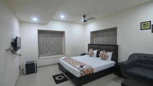 a bedroom with a bed and a couch in it at NK7 Guest House in Kolkata