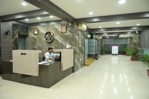 a person sitting at a desk in a lobby at NK7 AL Newtown in Kolkata