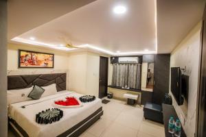 a bedroom with a bed with a bowl of fruit on it at HOTEL PARAMESHWARA luxury awaits in Vijayawāda