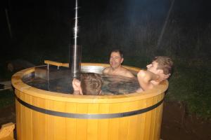 two men in a jacuzzi in a hot tub at Slnečný dom in Liptovské Revúce