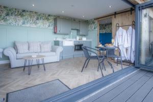 a living room with a couch and a table at The Langland bay look out in Swansea