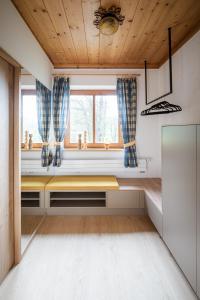 a room with a window and a wooden ceiling at Ferienhäuschen Millinghof in Leogang