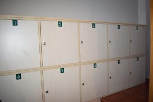 a room with white cabinets with green numbers on them at Tras do convento in Samos