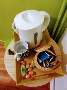 a table with a coffee cup and a box of candy at Le Passe-Port pour Marseille in Marseille