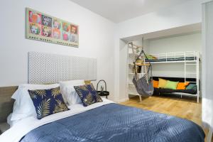 a bedroom with a bed and a swing at Lumina apartment with balcony overlooking the park in Łódź