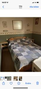 a bedroom with a bed with a checkered blanket at Fritidshus i Sandbergen in Stora Frö