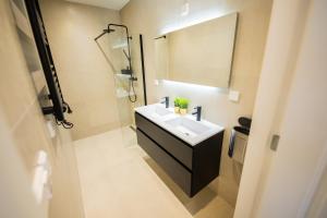 a bathroom with a white sink and a shower at Dearly 1 Bedroom Serviced Apartment 56m2 -NB306D- in Rotterdam