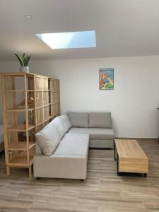a living room with a couch and a coffee table at Grand studio neuf à Carry le Rouet in Carry-le-Rouet