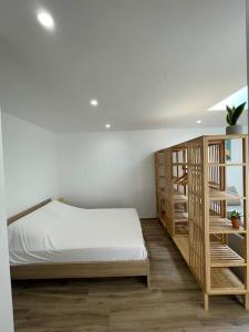 a bedroom with a bed and a book shelf at Grand studio neuf à Carry le Rouet in Carry-le-Rouet
