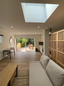 a living room with a couch and a table at Grand studio neuf à Carry le Rouet in Carry-le-Rouet