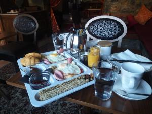 a table with a tray of breakfast food on it at Arolithos-Kaimaktsalan in Palaios Agios Athanasios