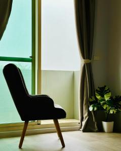 a black chair sitting in front of a window at 小逗民宿 in Taitung City