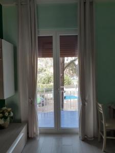 a sliding glass door with a view of a pool at Luli Holidays Paestum in Paestum