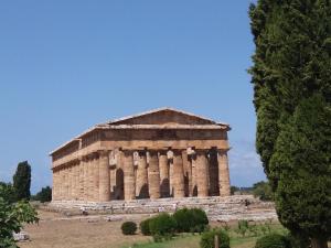 an ancient building with columns in a field at Luli Holidays Paestum in Paestum