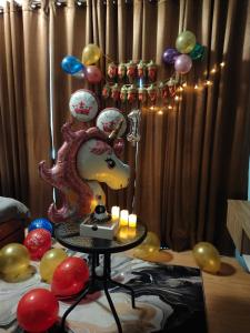 a room with balloons and a table with a lamp at SwissBelResidence Studio With King Bed in Kuantan +112 photos