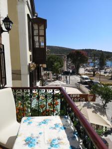 a balcony with a bench with a view of a street at Marinda Otel in Cesme