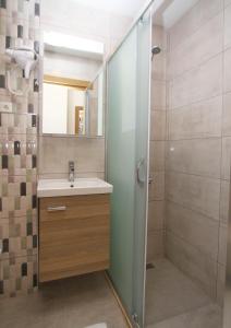 a bathroom with a sink and a shower at Marinda Otel in Cesme