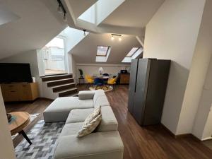 a living room with a couch and a table at Aneri Apartment Old Town in Bratislava