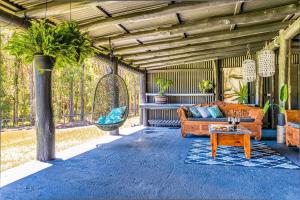 a living room with a couch and a table at Sunshine Coast Farm Stay in Glass House Mountains