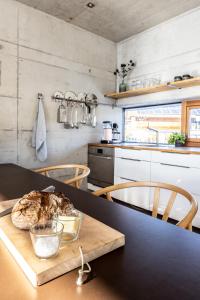 a kitchen with a table with a loaf of bread on a cutting board at Bleibe in Bad Kohlgrub