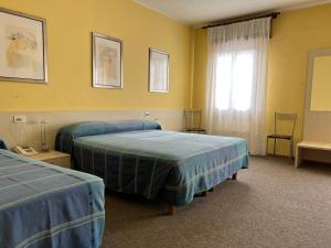 Postel nebo postele na pokoji v ubytování Hotel Giardino