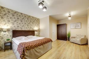 a bedroom with a large bed and a chair at Narva-Jõesuu Medical Spa in Narva-Jõesuu