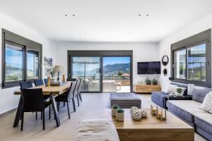 a living room with a table and a couch at Villa Antigone Luxury Retreat in Skopelos Town