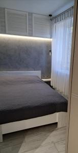a bedroom with a bed and a window at super apartment on O.Polya 137 in Dnipro