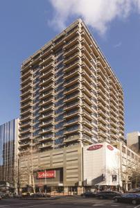 a large building with a lot of windows at Adina Apartment Hotel Melbourne in Melbourne +86 photos