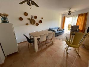 sala de estar con mesa de comedor y sillas en Luminoso y tranquilo bajo con Jardin en campo de Golf Valle del Este, en Vera