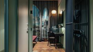a hallway with a desk and a table with chairs at Liseberg Grand Curiosa Hotel in Gothenburg