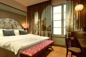 a bedroom with a large bed and a window at Liseberg Grand Curiosa Hotel in Gothenburg