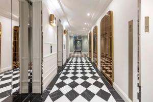 a hallway with a black and white checkered floor at Adina Apartment Hotel Brisbane in Brisbane