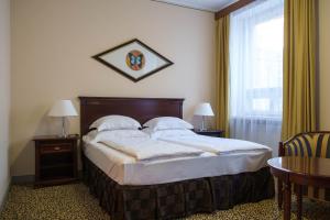 Postel nebo postele na pokoji v ubytování Grand Hotel Viljandi