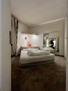 a room with three beds in it with a mirror at Insieme è più bello in Sauze dʼOulx