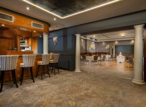 a dining room with tables and chairs and a bar at Ardboyne Hotel in Navan