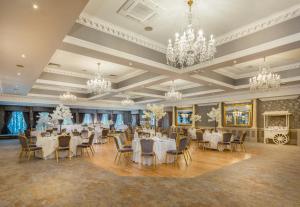 a banquet hall with tables and chairs and chandeliers at Ardboyne Hotel in Navan