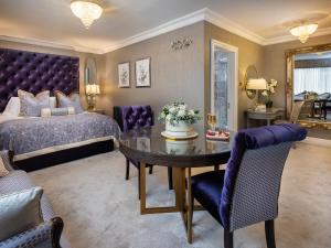 a bedroom with a bed and a table and chairs at Ardboyne Hotel in Navan