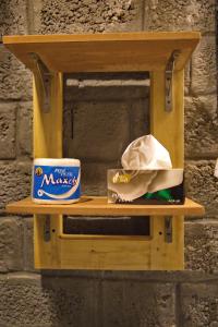 a wooden shelf with a box of mozzarella cheese and a can of mo at Baltistan Fort Skardu Resort in Skardu