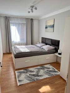 a bedroom with a bed and a window at MaHome Apartments in Lofer