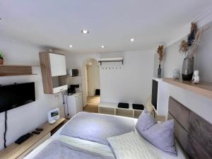 a living room with a bed and a tv at MaHome Apartments in Lofer