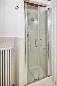 a shower with a glass door in a bathroom at Loft del porto in Fano