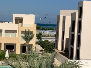 a view of a building with the ocean in the background at Elgouna Hurghada egypt mangroovy in Hurghada