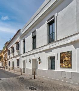 a building with a painting on the side of it at Hotel Boutique Triana House in Seville