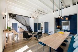 a dining room and living room with a table and chairs at iGadi House Boutique Hotel in Cape Town