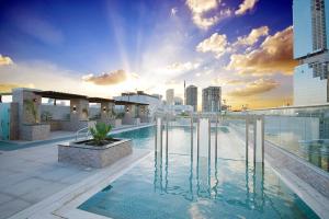 a swimming pool on the roof of a building at KeyHost - 1BR Apartment Near Five Hotel JVC - K141 in Dubai