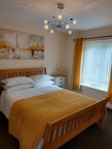 a bedroom with a large bed and a window at The Chalet in Radstock