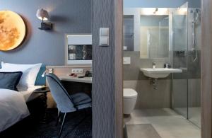 a bathroom with a sink and a toilet and a shower at Leonardo Boutique Hotel Krakow Old Town in Krakow
