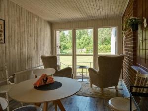a room with chairs and a table and a window at Herrestad Bed & Guestroom in Värnamo