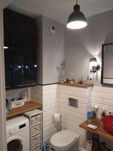 łazienka z toaletą i pralką w obiekcie NightHost Kleczkowska 49 m53 Wrocław we Wrocławiu